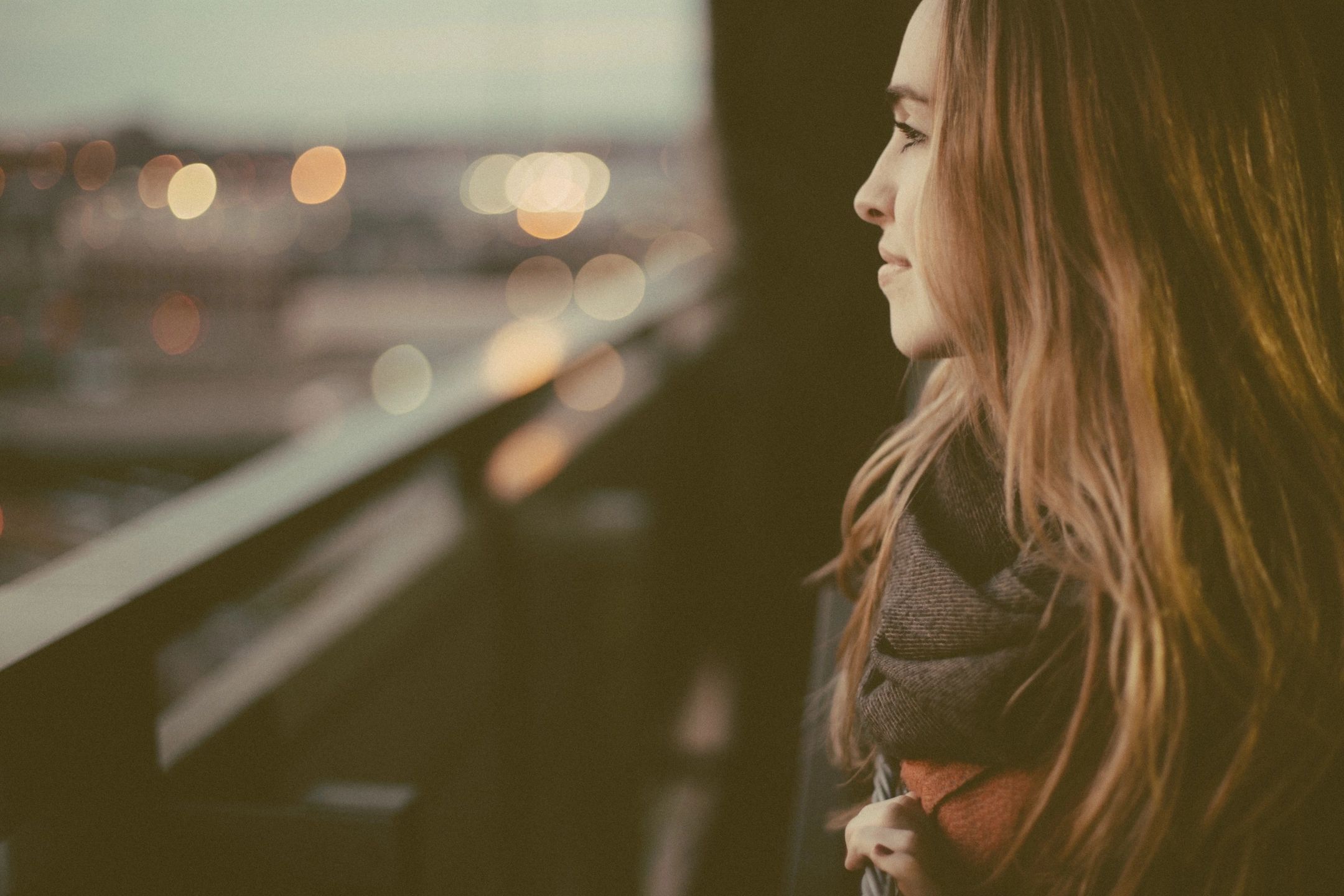 woman smiling looking at view of city